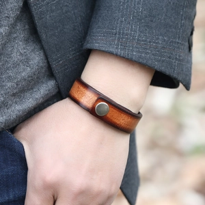 Vintage brown leather bracelet for men with distressed metal buckle on model