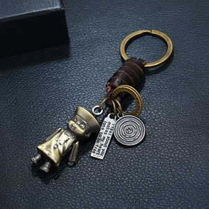 Punk vintage woven leather keychain with bronze figurine and engraved plaque on black leather