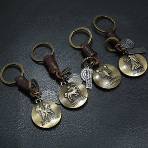 Vintage braided leather keychain set with brass zodiac pendants and inspirational tags