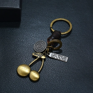 Retro men's woven leather keychain with bronze cherry pendants and engraved tags