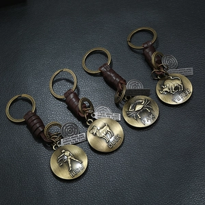 Retro zodiac leather keychains with bronze charms for Libra, Aries, Cancer, and Taurus signs