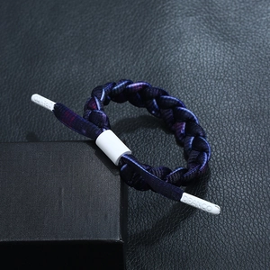 Close-up of braided blue and purple bracelet with DPANCO logo buckle and slider