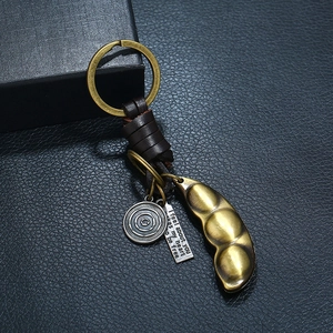 Vintage bronze pea pod pendant keychain with woven leather strap and inspirational tag