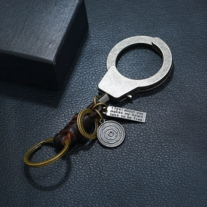Retro handcuff metal keychain with dark brown leather strap and engraved heart pendants