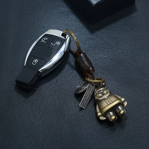 Handmade leather keychain with vintage bronze Santa pendant and metal charms on car key