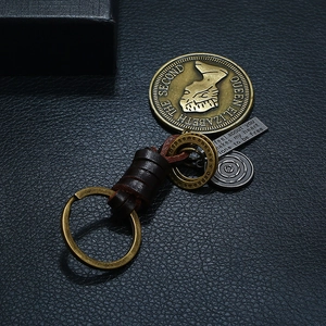 Punk woven leather keychain with vintage brass coin pendant and engraved metal tag