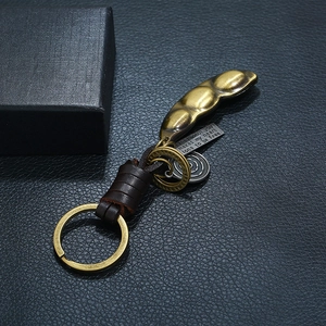 Vintage alloy pea pod keychain with genuine brown leather strap and engraved quote tag