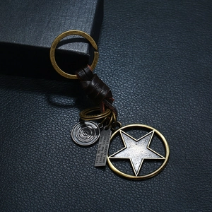 Handmade woven leather keychain featuring vintage alloy star pendant and engraved metal tag
