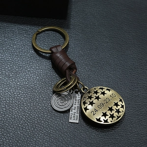 Vintage braided leather keychain with bronze zodiac charms and engraved metal plates