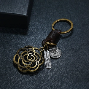 Retro handmade leather keychain with bronze hollow rose and engraved metal charms