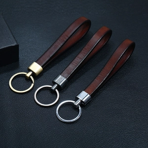 Three premium brown leather keychains with gold, silver, and gunmetal hardware finishes