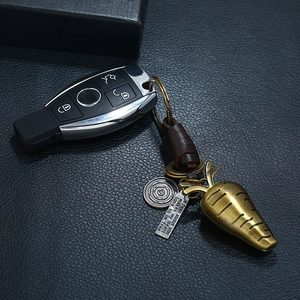 Vintage brass carrot keychain with braided leather strap and engraved metal plate tag