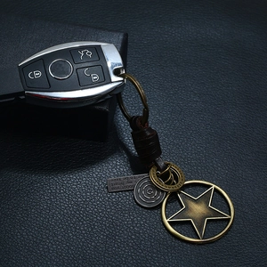 Vintage woven leather keychain with alloy star pendant and engraved metal charms