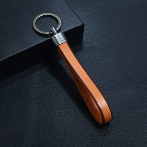 Close-up of premium brown leather keychain with vintage matte gunmetal finish ring