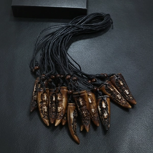 Ethnic style resin necklace featuring hand-carved tribal faces and dark wooden beads