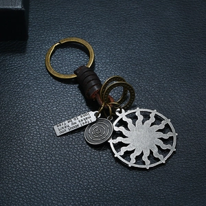 Handcrafted vintage leather keychain with sun pendant and engraved metal tags