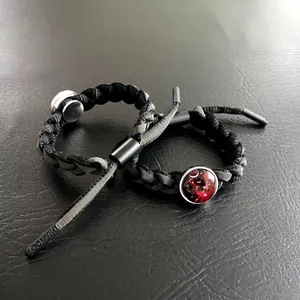 Braccialetti in corda nera intrecciata con ciondoli zodiacali e terminali logati