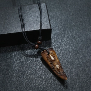 Vintage resin necklace for men with carved relief pendant on black braided rope