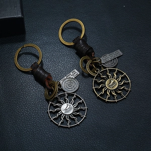 Vintage handmade leather keychain with sun pendant and engraved metal quote plate