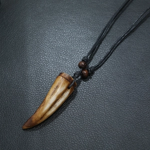 Vintage resin fang pendant necklace with brown texture and black braided cord