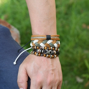 Bohemian multilayer woven leather bracelet set with metallic beads on a male wrist