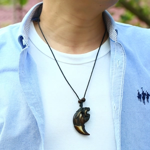 Vue rapprochée du pendentif tête de lion punk sur cordon noir porté par un mannequin