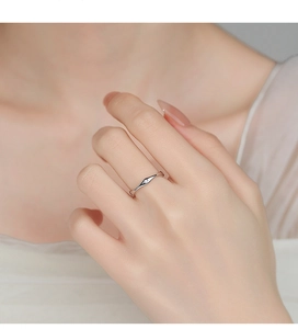Detailed view of a silver minimalist ring with a tiny zircon in diamond-shaped setting