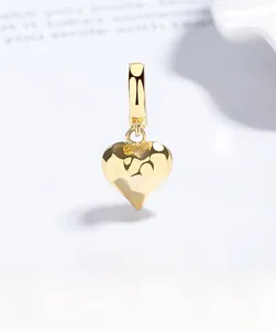 Macro shot of 925 sterling silver heart pendant with textured gold plated finish