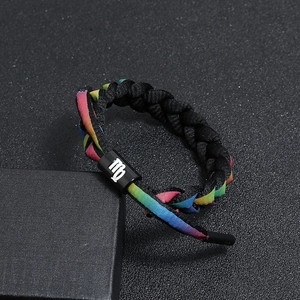 Macro shot of Virgo zodiac bracelet featuring black braided rope and colorful gradient lace