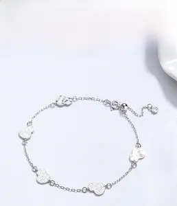 Detailed macro of S925 silver bracelet with hammered gourd charms and zircon drop
