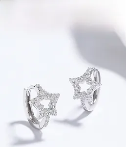 Macro view of 925 sterling silver star hoop earrings with pavé cubic zirconia detail