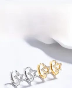 Detail of 925 sterling silver star hoop earrings with sparkling cubic zirconia stones