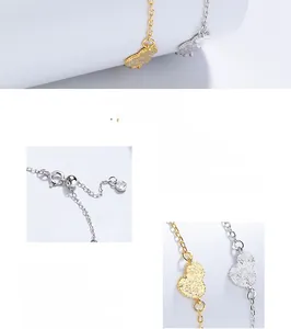 Macro detail of 925 sterling silver heart charms showing polished finish and O-chain links