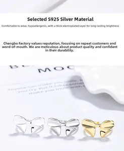 Detail of bow-shaped S925 silver rings with thick electroplating for allergy protection