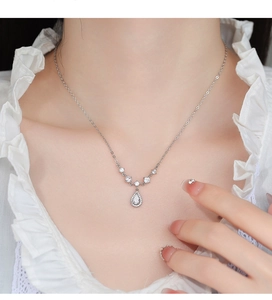 Close-up of S925 silver water drop pendant necklace with zircons on a model