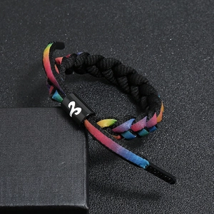 Detail of Aries constellation charm on a rainbow gradient braided bracelet cord