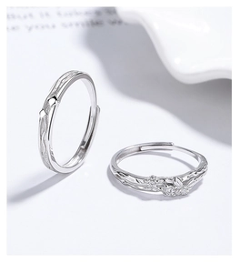 Macro shot of 925 silver butterfly couple rings with wave texture and zircon inlay