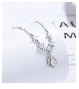 Macro shot of 925 silver pear-shaped pendant necklace with clear zircon stone detailing