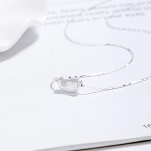 Minimalist 925 sterling silver pea necklace with a matte finish pendant on white background