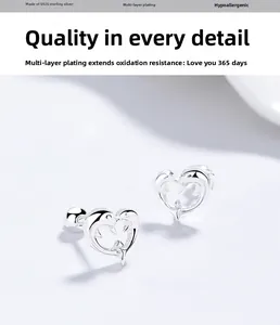 Macro shot of 925 sterling silver dolphin heart earrings with detailed polished finish