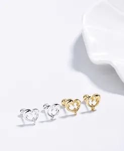 Detailed view of S925 sterling silver dolphin heart earrings in gold and silver finishes