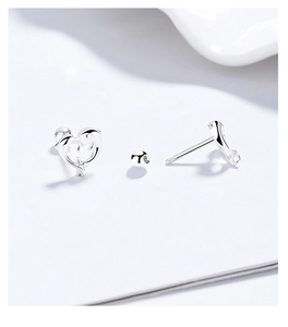 Detail view of S925 silver dolphin heart earrings featuring secure screw-back closures