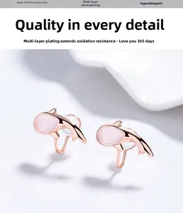 Macro detail of rose gold S925 sterling silver dolphin earring with pink cat eye stone