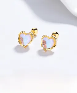 Macro shot of 925 silver heart-shaped moonstone stud earrings with screw-back design