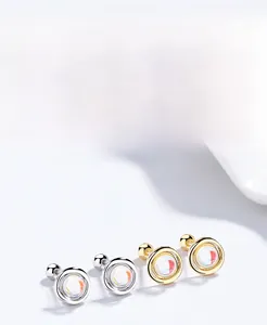Macro shot of S925 sterling silver moonstone stud earrings in silver and gold finishes