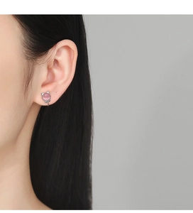 Detail of cute silver cat ear clip with pink opal stone worn by a female model