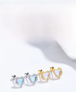 Detailed view of S925 silver heart stud earrings with rainbow opal inlay and gold plating