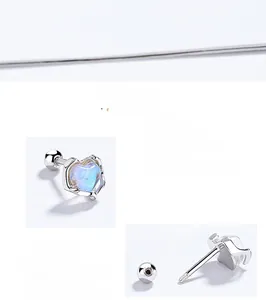 Macro detail of 925 silver heart stud with moonstone inlay and screw back closure