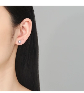 Detailed view of minimalist S925 silver stud earring with zircon on model ear