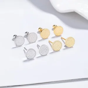 Detail of 925 silver stud earrings with hexagonal honeycomb texture in gold and silver